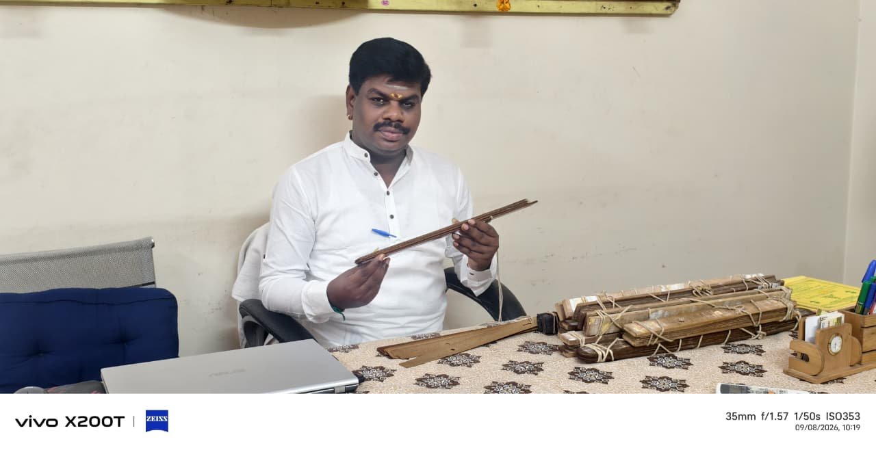 Guruji holding the stylus and a palm leaf